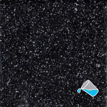 The name of this aquaBRIGHT color swatch is "Perle Noire". It's a sample of a dark-colored pool finish. The surface is composed of a dense mix of tiny, irregularly shaped white, and black specks, giving it a speckled, granite-like appearance.